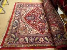 Highly decorated middle eastern red ground carpet