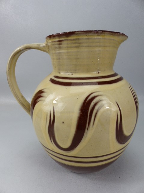 Large bulbous slipware glaze jug in cream and earthenware red. Marked to base L'Etacq, Jersey JW. - Image 2 of 5