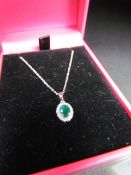 18CT white gold emerald and diamond pendant necklace on gold chain cased approx 1/2ct