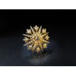 15ct Gold starburst brooch/pendant set with seed pearls and a central old mine cut diamond approx