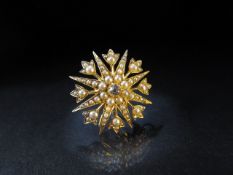 15ct Gold starburst brooch/pendant set with seed pearls and a central old mine cut diamond approx