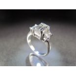 White Gold three stone Diamond ring. The Emerald Cut centre stone is approx 2.2ct, measuring