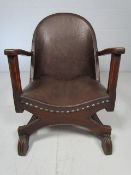 Low unusual shaped chair with X front support and reeded style legs. The seat and back both