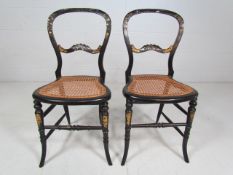 Victorian pair of ebonised chairs inlaid with mother of pearl and lattice seats