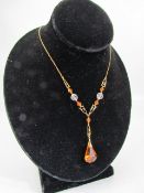 Vintage necklace signed by W. Bs. Amber coloured pendant on ornate gold coloured chain.