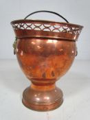 Antique Copper Wine Cooler with pierced top and Lion head handles.