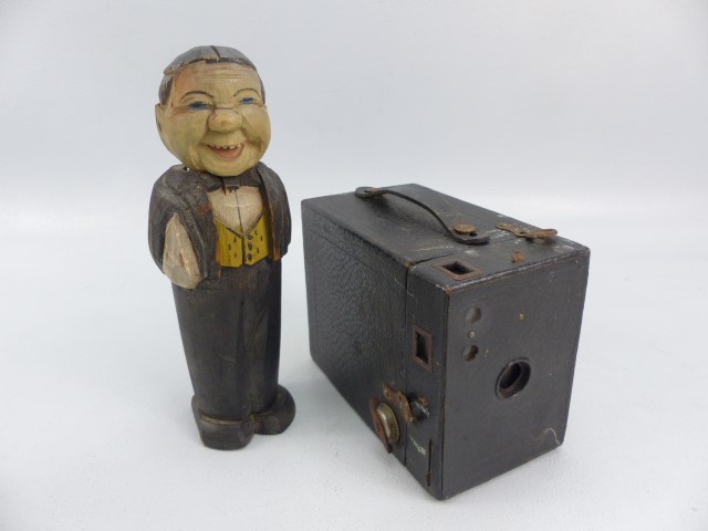 Antique carved wooden man in the form of a brush holder and a vintage camera ' No2 Cartridge Hawk-