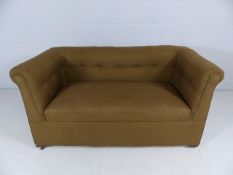 Small antique upholstered two seater sofa on castors