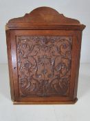 Oak hanging corner cupboard with carved front