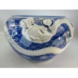Chinese Jardiniere in blue and white with trailing three clawed dragon decoration.