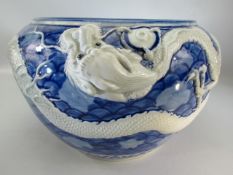 Chinese Jardiniere in blue and white with trailing three clawed dragon decoration.