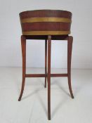 Antique wooden and brass bound wine cooler mounted on stand