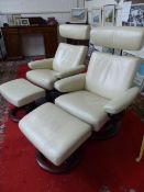 Two stressless leather chairs and matching footstools