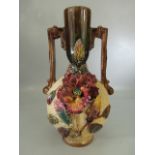 Majolica style twin handled vase with applied flowers
