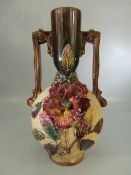 Majolica style twin handled vase with applied flowers