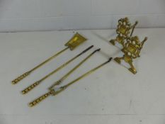 Brass antique fire dogs in the manner of christopher dresser with similar companion set