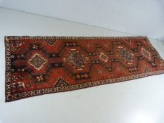 Red ground Iranian runner with medallion design