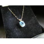 9ct blue coloured stone set pendant on a fine 9ct chain