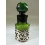 Antique green medicine bottle mounted with filigree silver work. Hallmarked for London 1902.