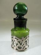 Antique green medicine bottle mounted with filigree silver work. Hallmarked for London 1902.