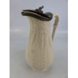 Saltglaze antique jug with pewter lid decorated with wheat patterns.