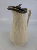 Saltglaze antique jug with pewter lid decorated with wheat patterns.