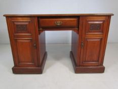 Arts and Crafts mahogany pedestal desk with carved cupboards