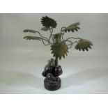 Mid Century 1970's bronze monkey holding a palm tree in the form of a candle holder