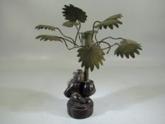 Mid Century 1970's bronze monkey holding a palm tree in the form of a candle holder