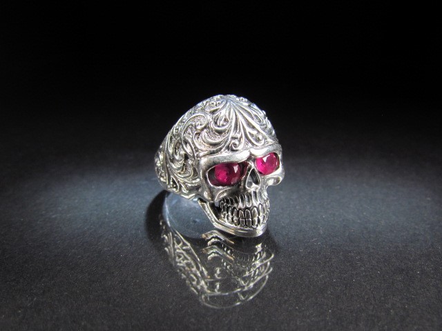 Unusual silver Skull ring set with ruby coloured eyes