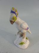 Meissen Miniature figure of a parrot with crossed sword marks to base.