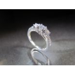 14ct White Gold Diamond ring. Three graduated central stones flanked by Diamond shoulders. Approx