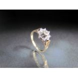 9ct Yellow Gold diamond flower head style ring. Approx weight - 2g