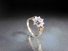 9ct Yellow Gold diamond flower head style ring. Approx weight - 2g