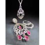 Silver pair of hoop earrings, pendant set with ruby and a necklace