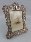 Hallmarked silver photo frame decorated with cartouche and flora