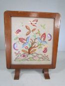 Antique stitch work tapestry mounted in a wooden fire screen frame