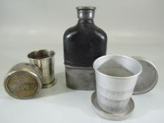 Pewter and leather bound flask along with an unusual brass stirrup cup and one other