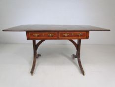 Edwardian sofa table inlaid with shell motifs and drawers.