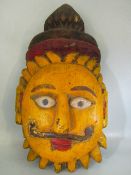 Large hardwood wall mask depicting a sun with a moustache