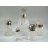 Collection of five cut glass bottles all with either hallmarked silver collars or hallmarked