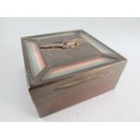 Square metal cigarette box bearing the RAF eagle emblem and four clear panels displaying the RAF