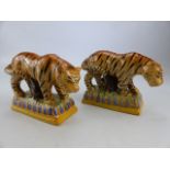 STAFFORDSHIRE - a pair of early 19th century Prattware Staffordshire Tigers. Both decorated with