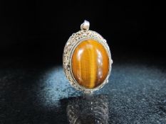 Silver sterling pendant set with Tiger's Eye cabochon stone