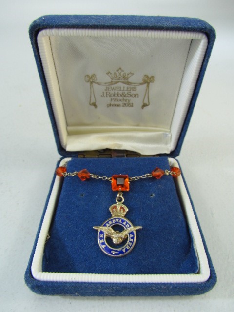 RAF mounted tag on necklace set with amber coloured stones.