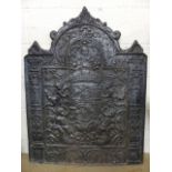 Antique style large cast iron fire back decorated with rearing lions and foliage.