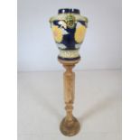 Coloured pottery jardiniere on turned wooden stand