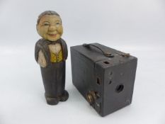 Antique carved wooden man in the form of a brush holder and a vintage camera ' No2 Cartridge Hawk-