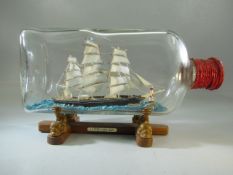 Cutty Sark ship in bottle on stand