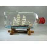 Cutty Sark ship in bottle on stand